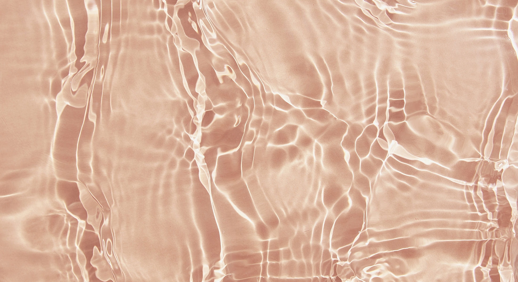 Rippling rose-colored water texture background.