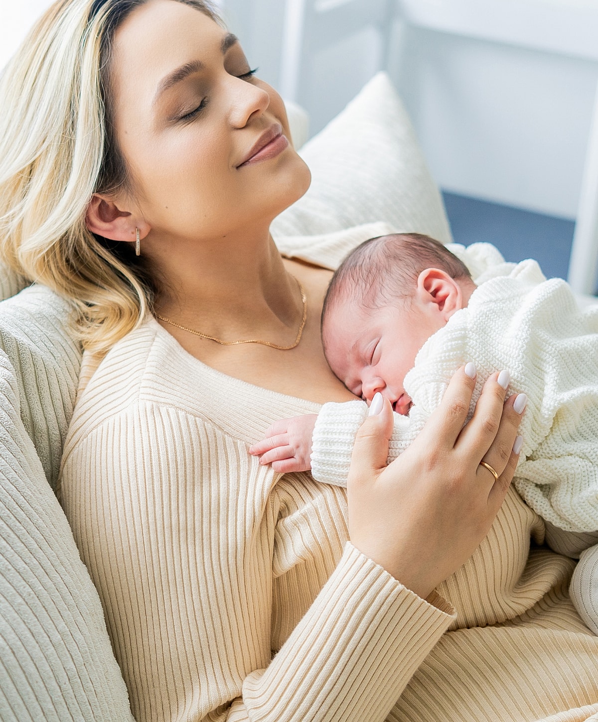 Mother lovingly holding her newborn baby.