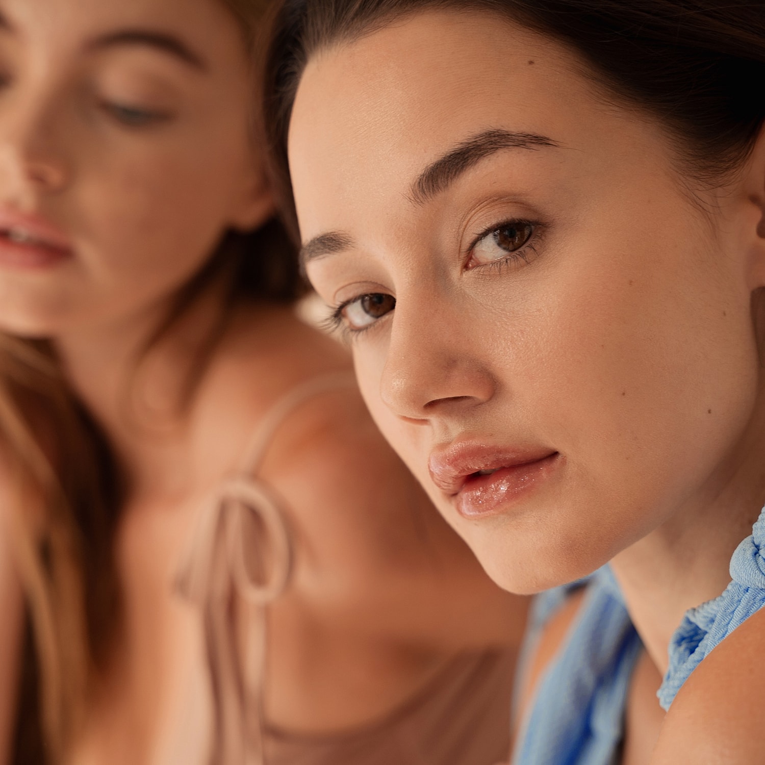 Close-up of two young women posing together.