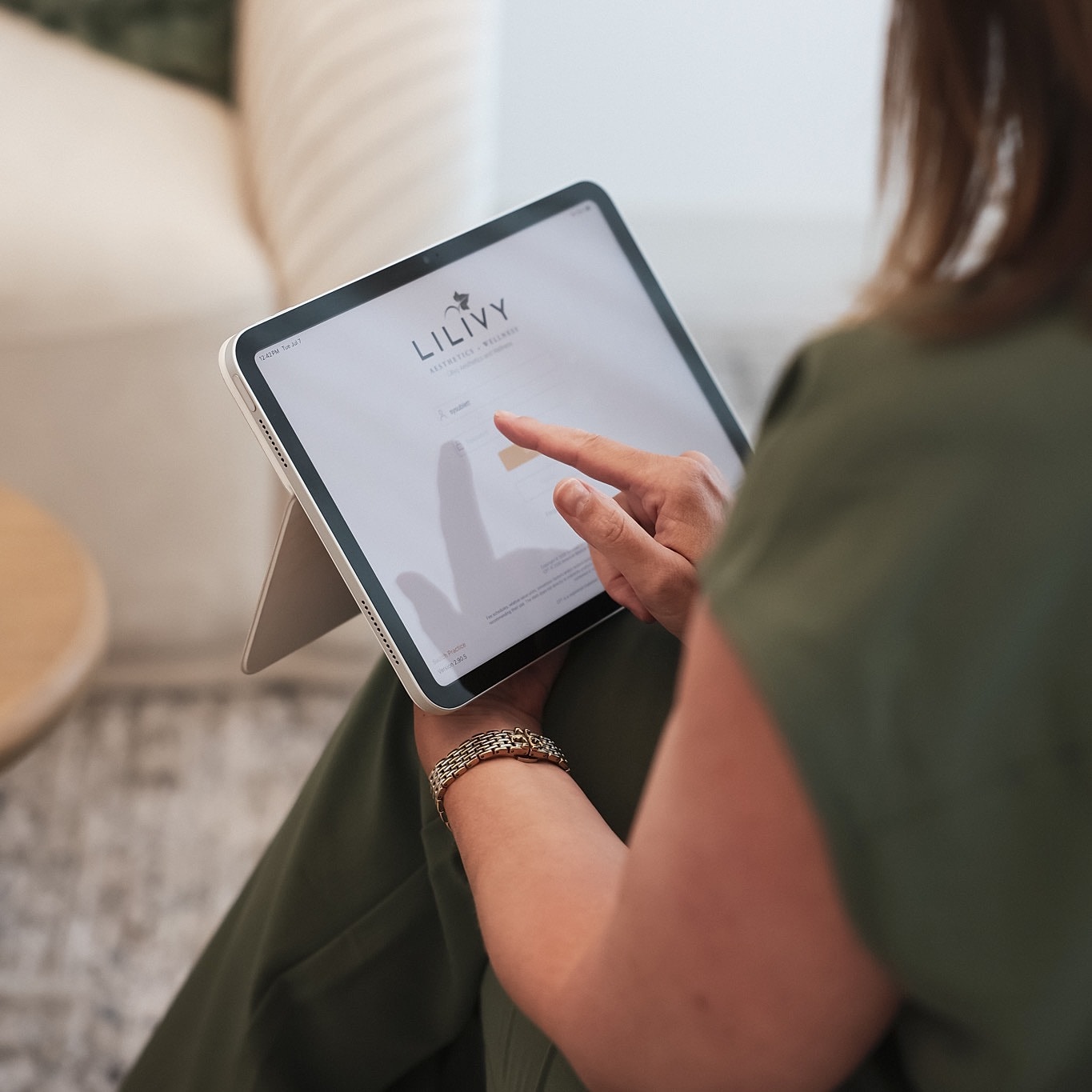 Person using tablet to access website.
