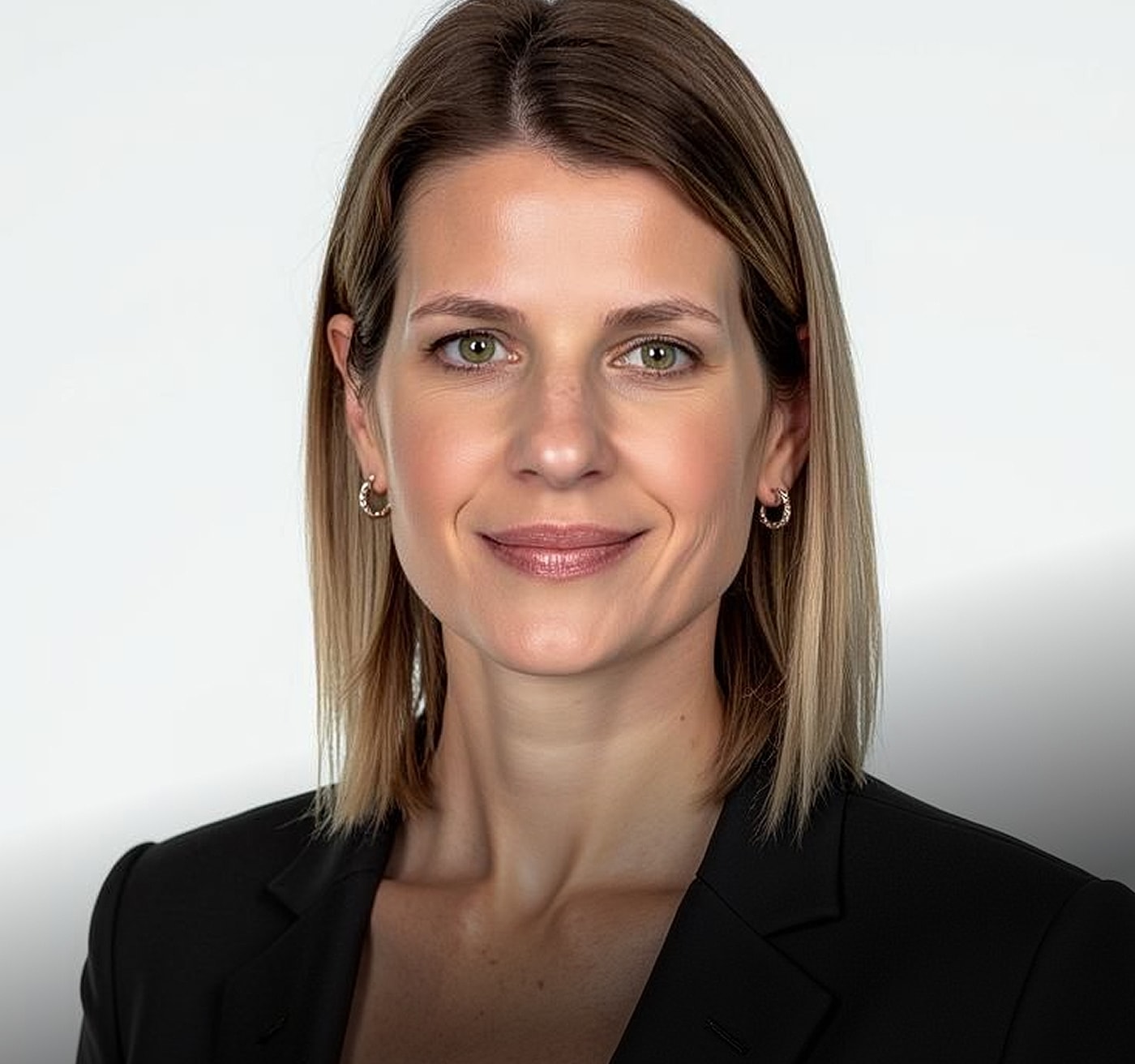 Professional woman smiling in business attire.
