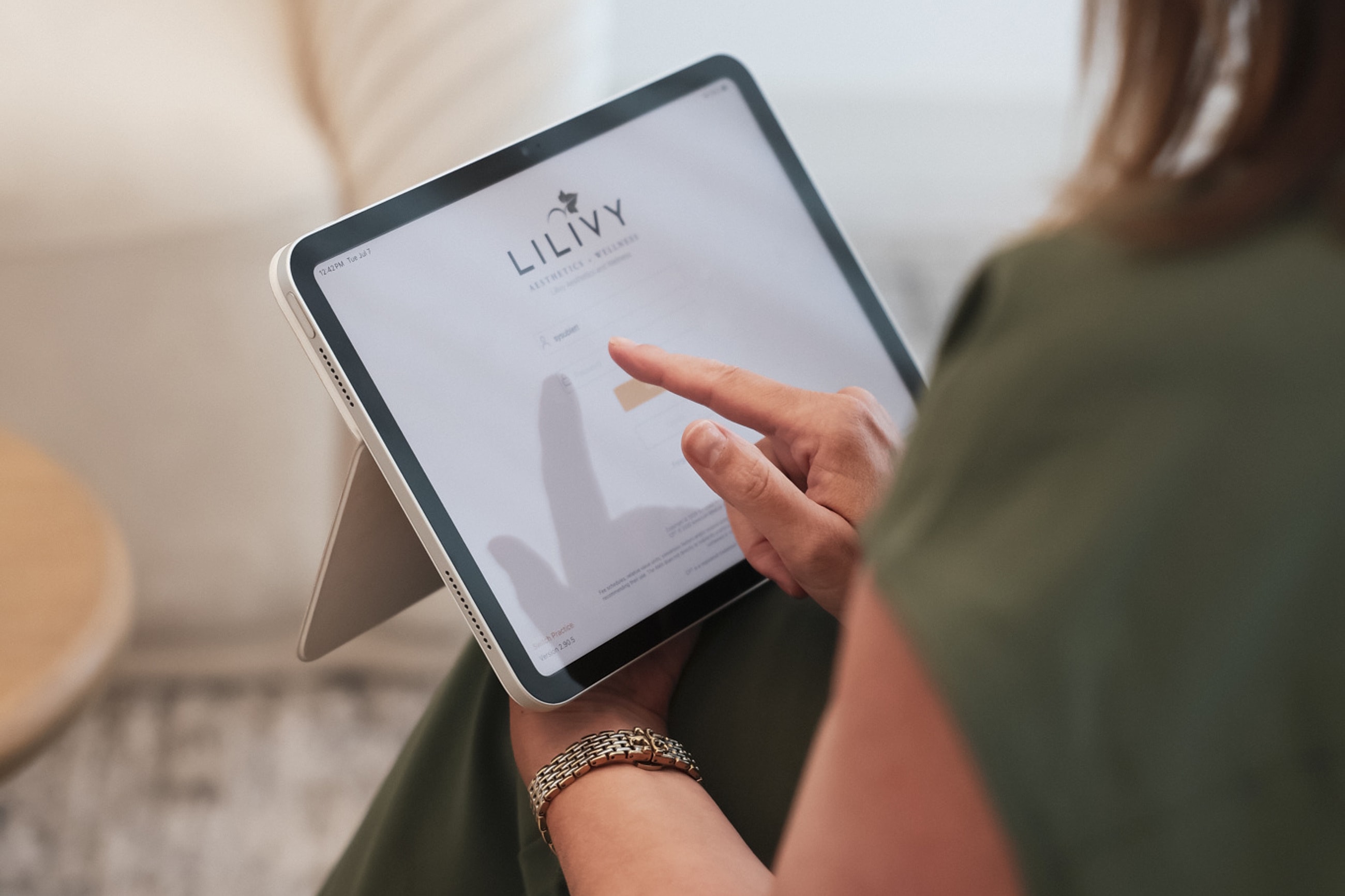 Person using tablet to log in to website.