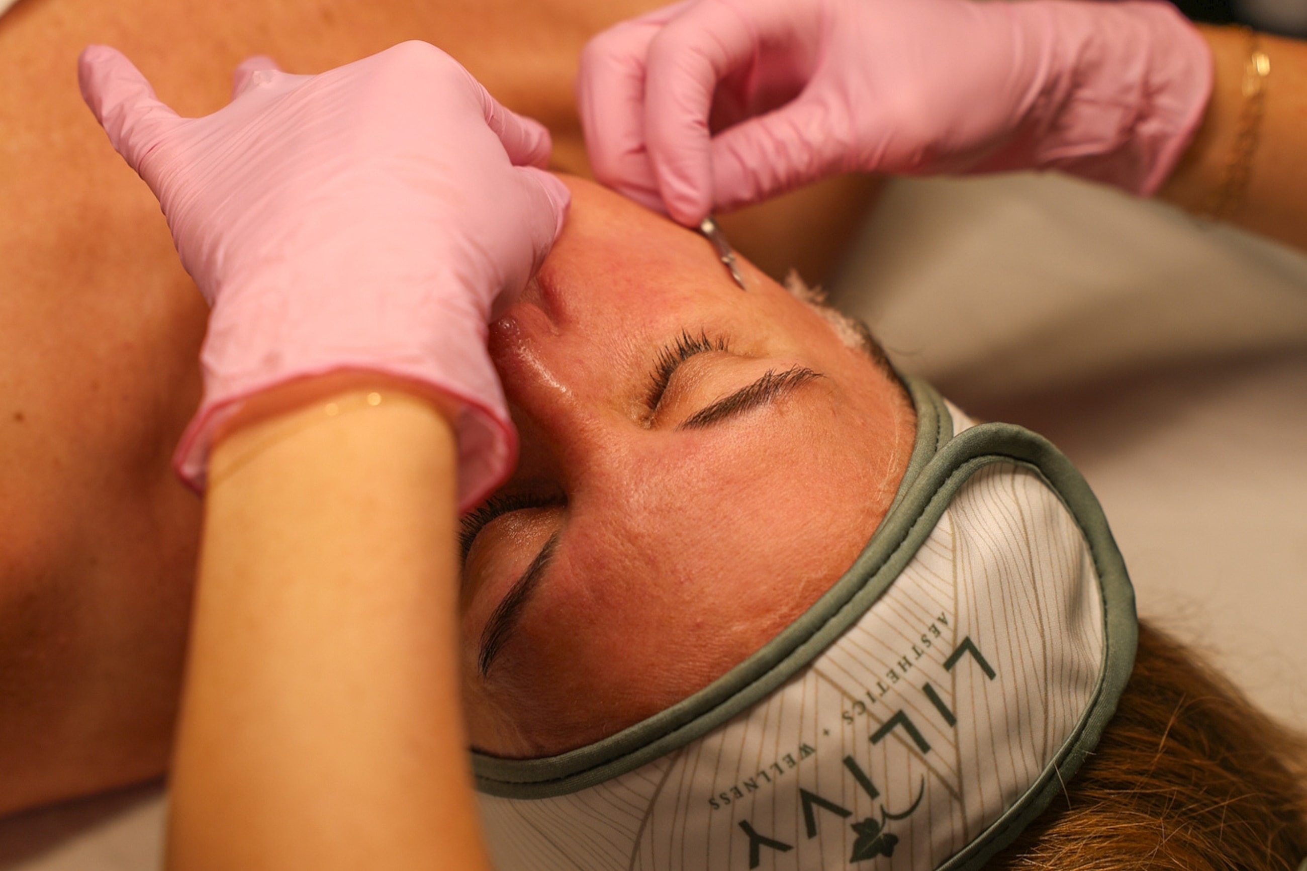Client receiving facial treatment in spa.