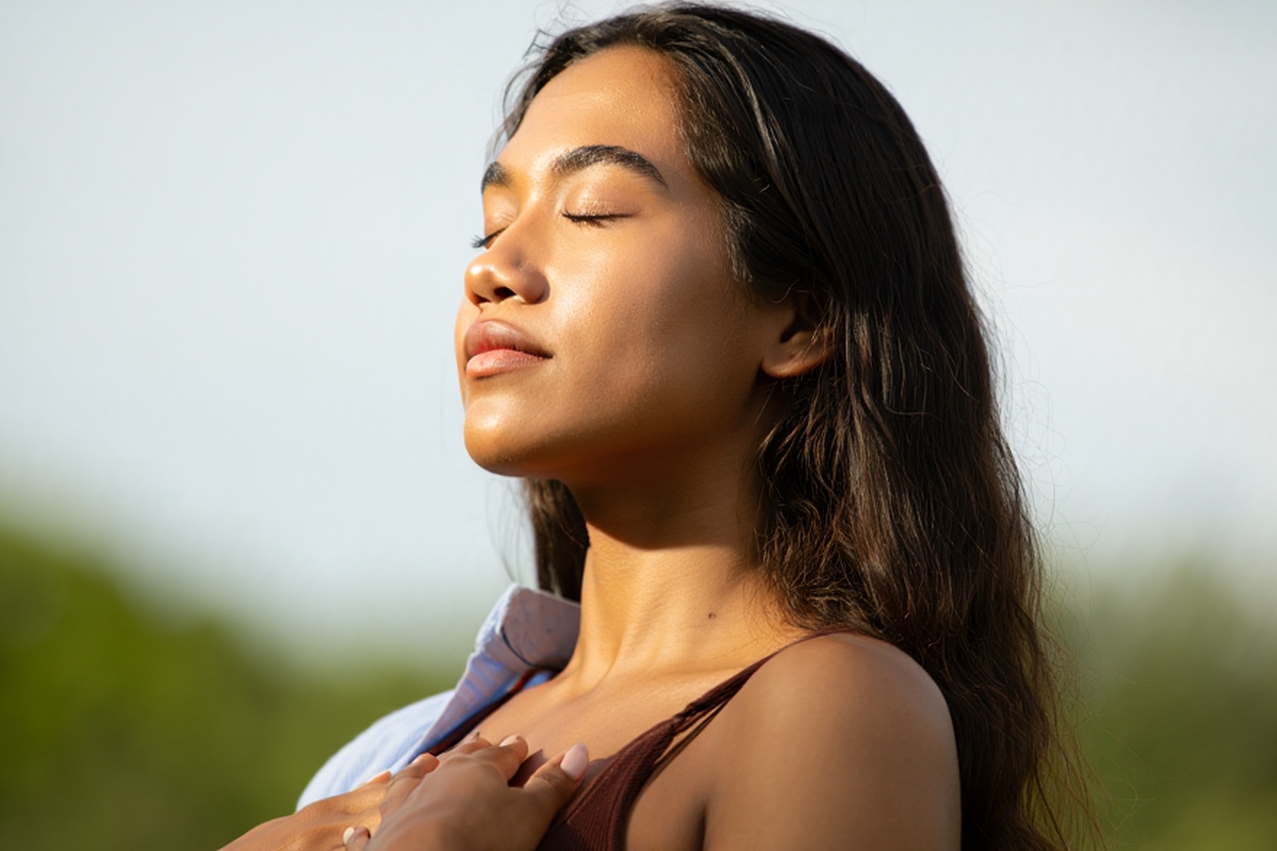 Woman enjoying the sun with closed eyes.